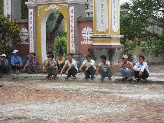 Asian men sitting on a curb (photo: gregwalters).