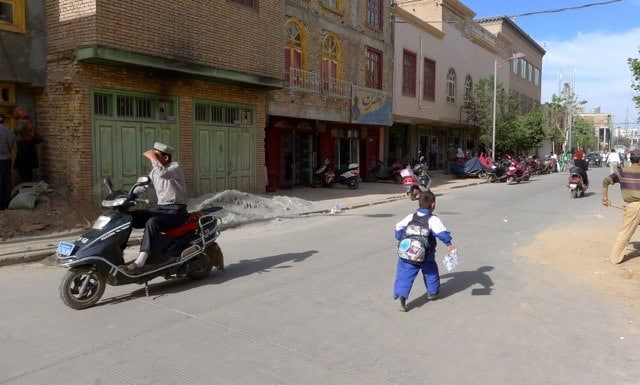 kashgar street boy running kashgar street boy running