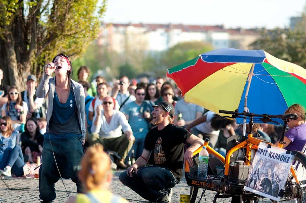 Singin' like she means it at Bearpit Karaoke. Image source.