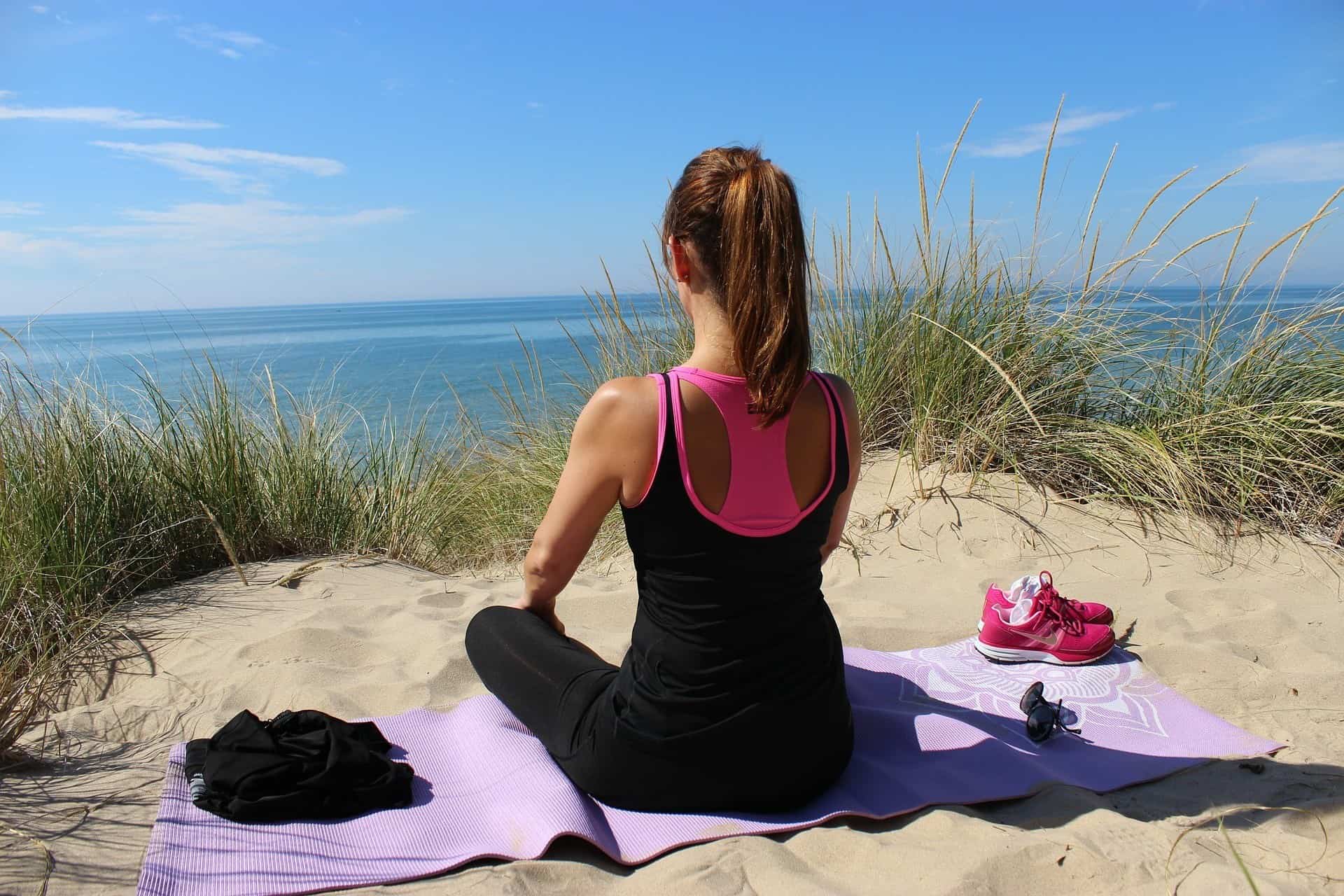 A woman doing bodyweight exercises at the beach