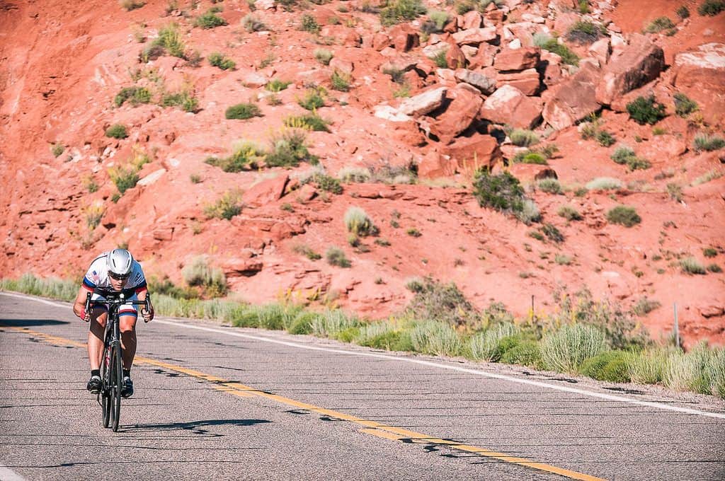 A cyclist competing in Race Across America in Monument Valley, Utah is an example of a sports holiday (photo: Race Across America).
