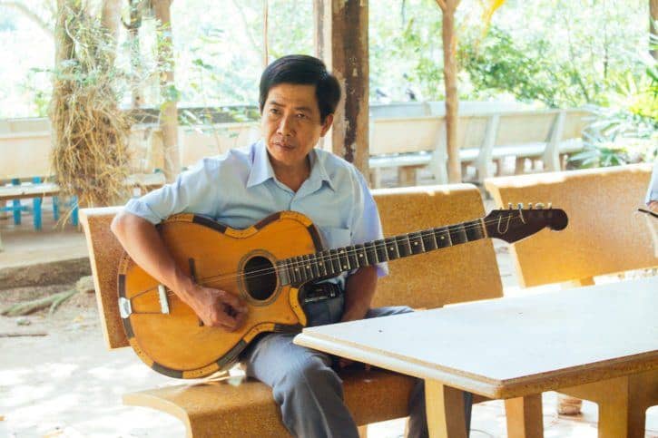 Guitar player on the Mekong River, Vietnam