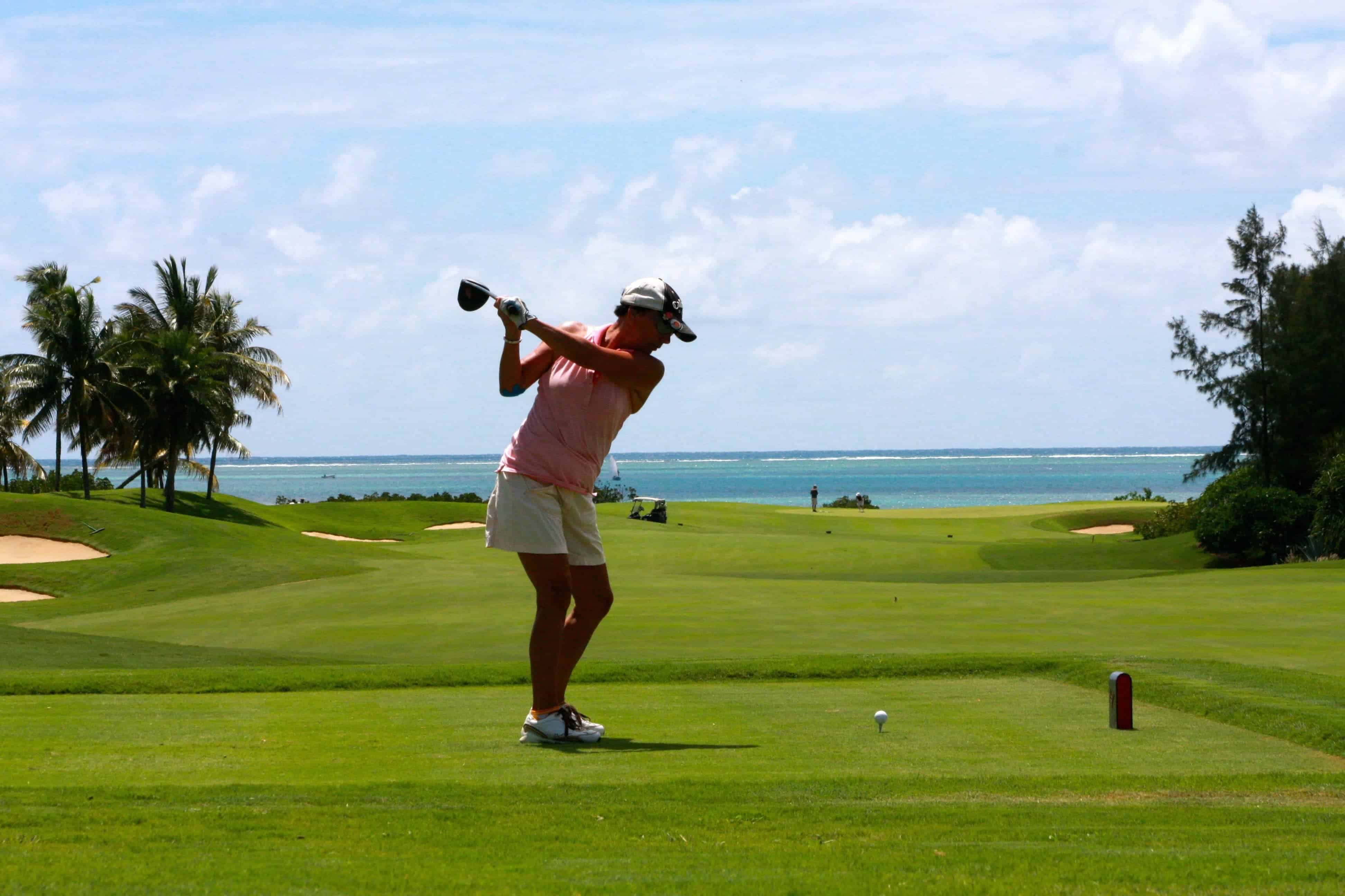 Playing golf.