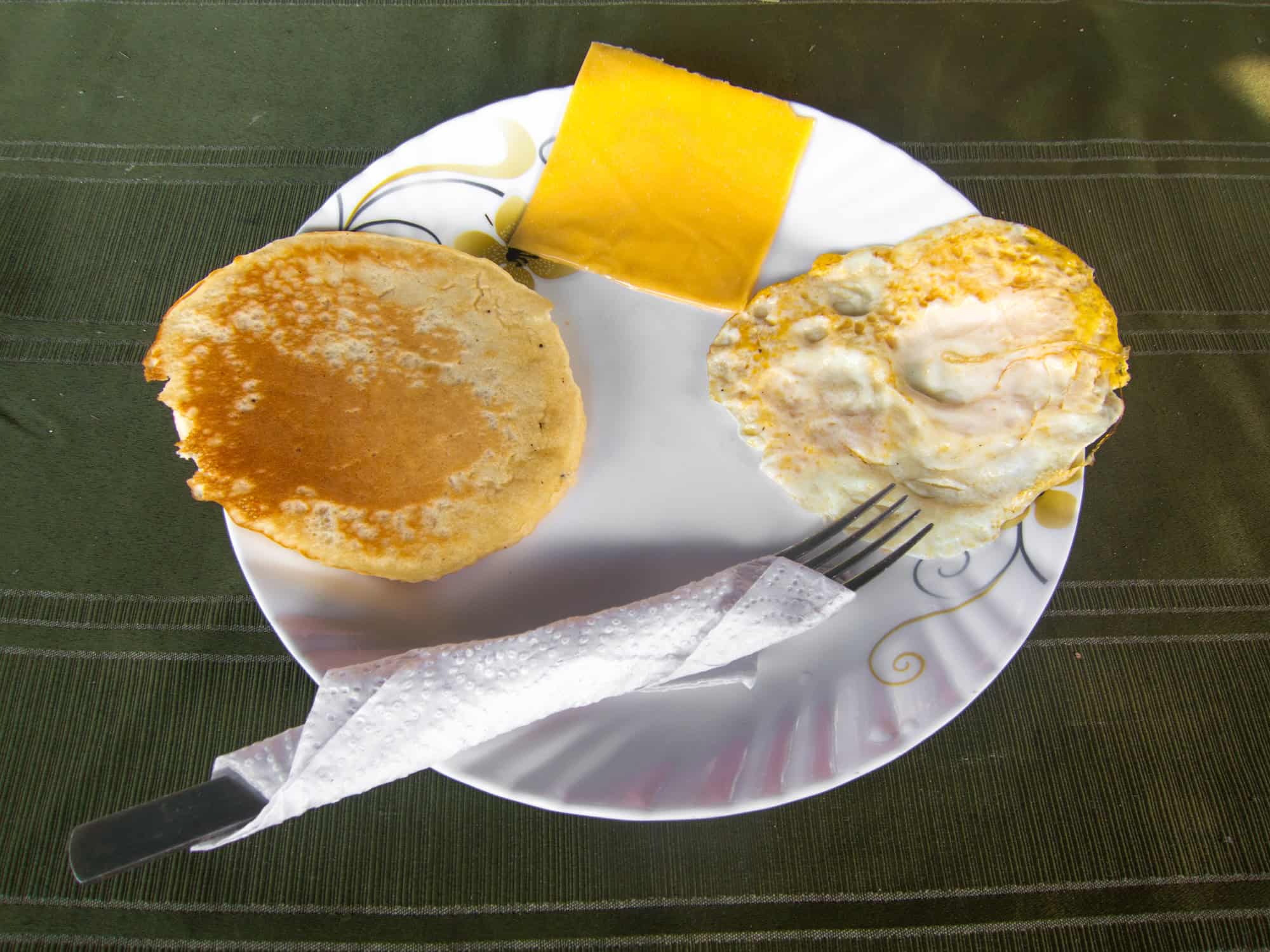 Pancake and fried egg for breakfast