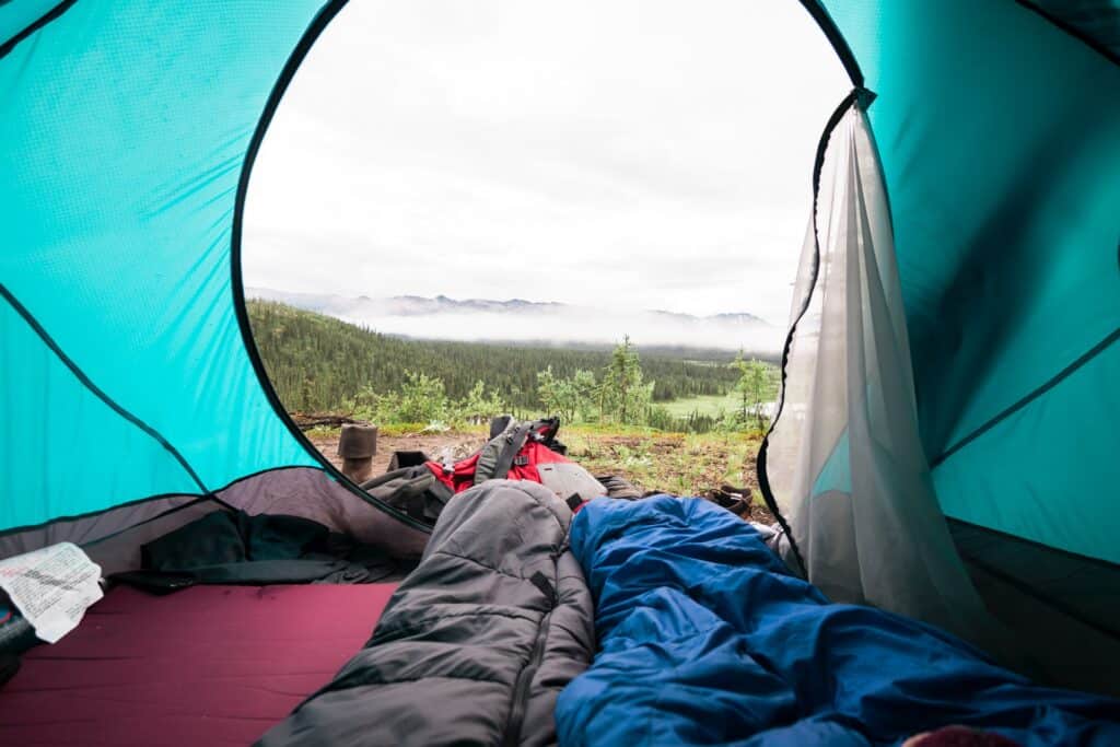Sleeping bag in tent (photo: Unsplash).