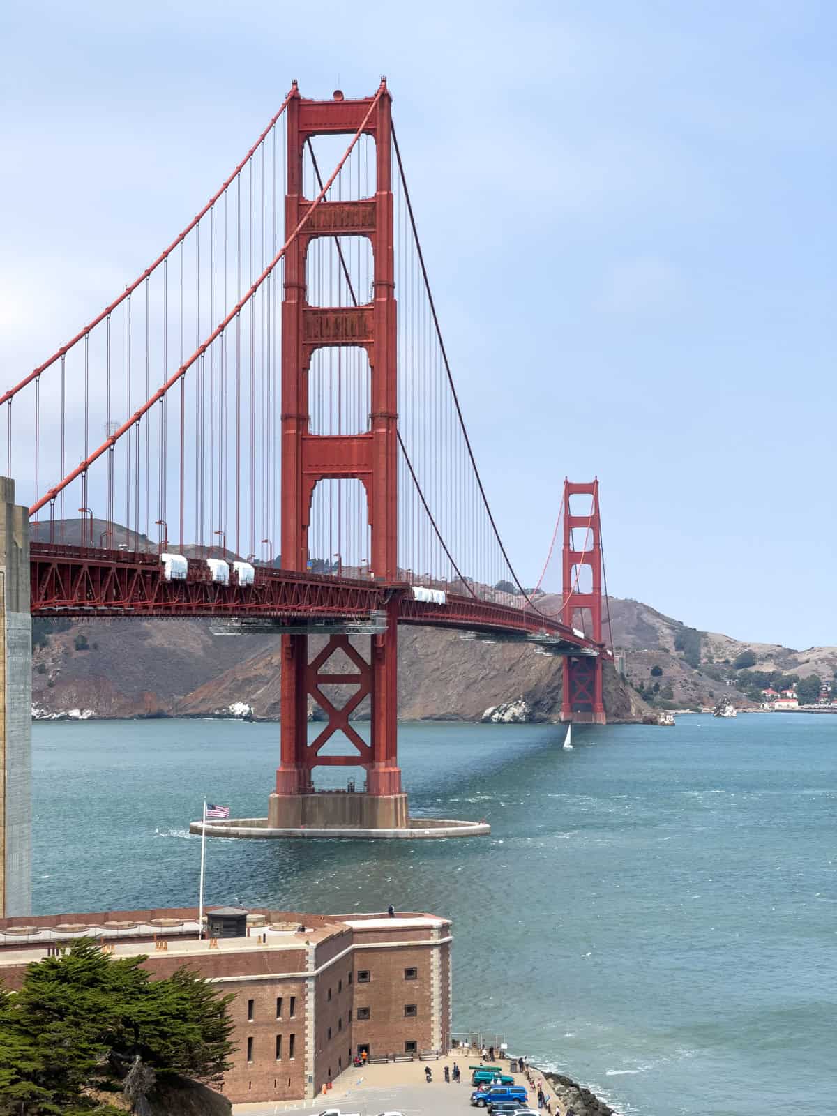 The Golden Gate Bridge towers over a Civil War fortress below it.