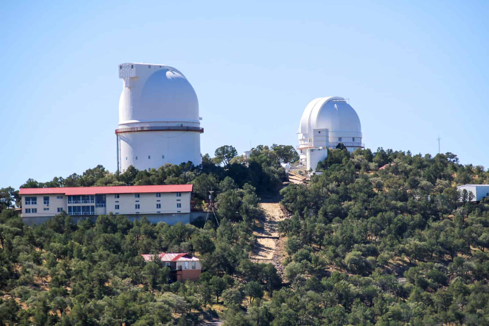 The Harlan J. Smith Telescope (left), Astronomers Lodge (bottom left), and Otto Struve Telescope (right) on Mt. Locke (photo: Kelly Lemons)