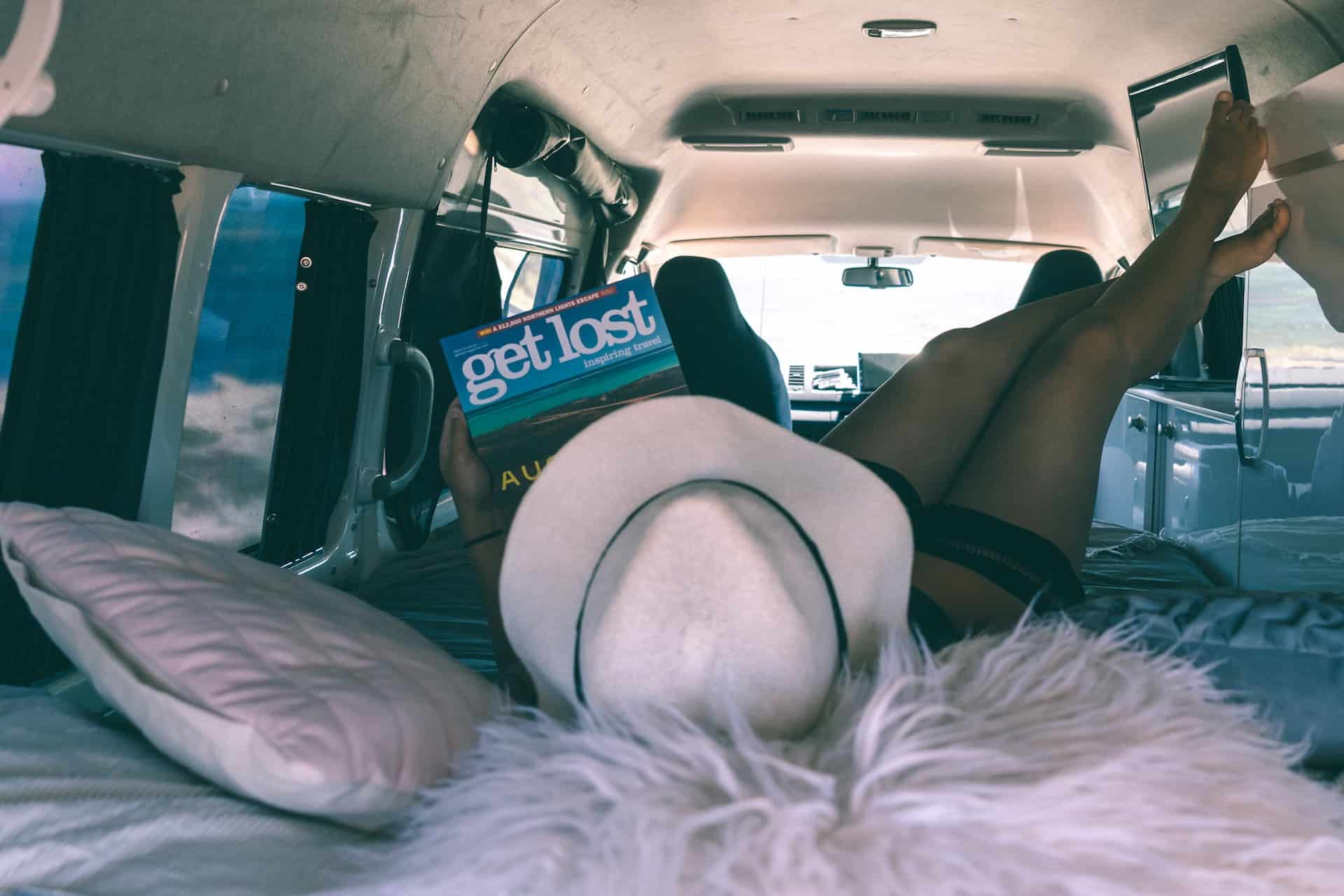 A woman relaxing in a campervan (photo: Jake Stone)