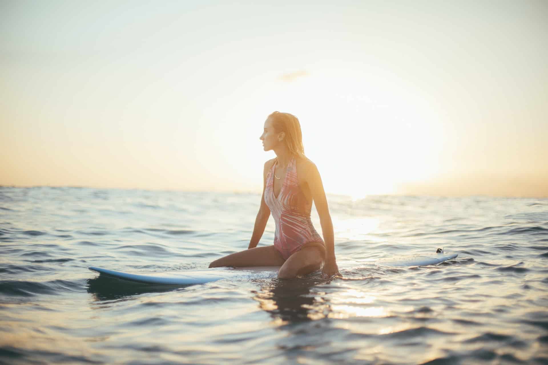 Female surfer in the water at Haleiwa, a top beach in Hawaii (photo: Chris Osmond)