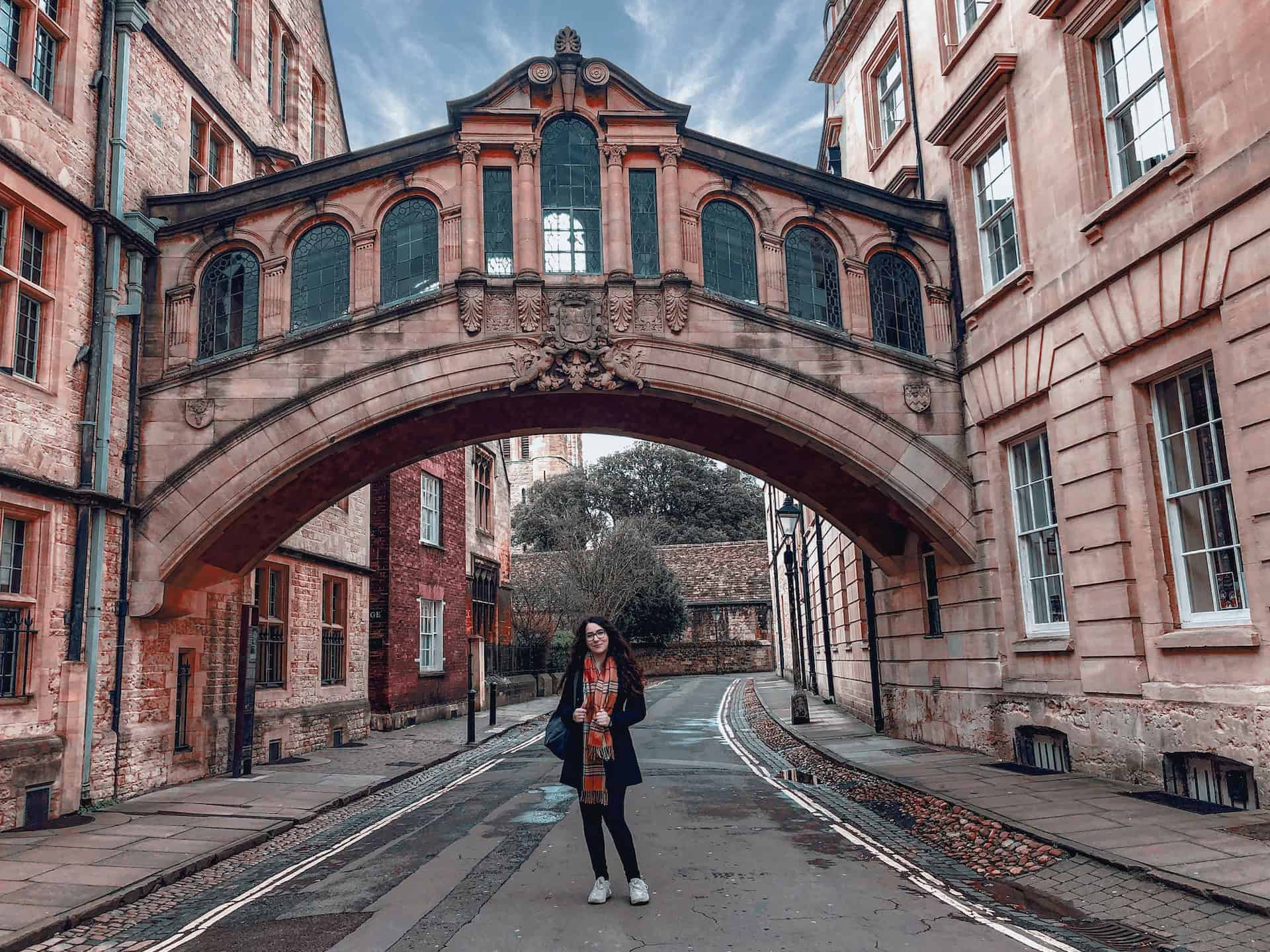 A woman poses on a charming street in Oxford, England (photo: Lucia Hatalova)