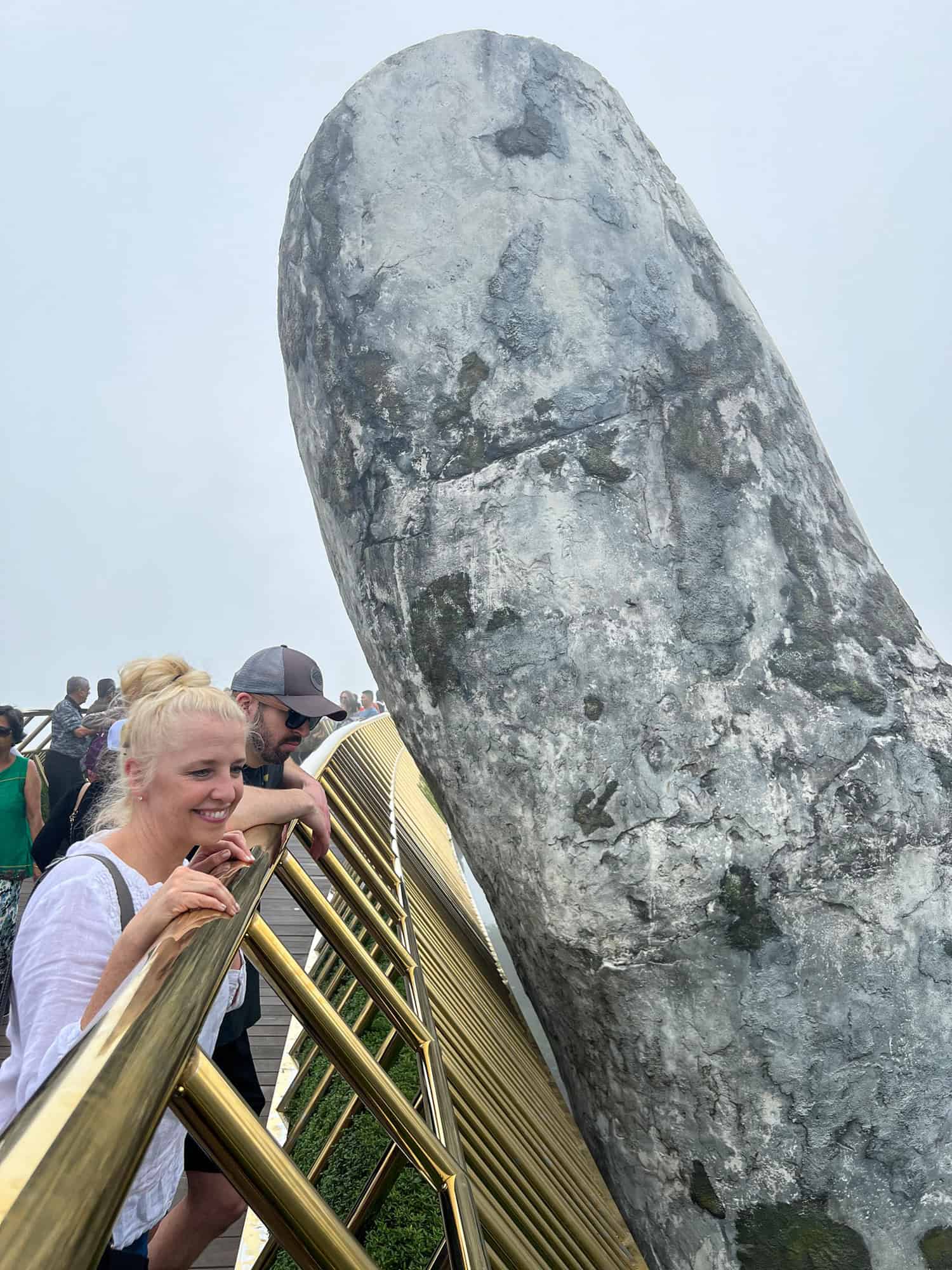 Our friends Laura and Bryan enjoy the beautiful scenery from the Golden Bridge in Vietnam.