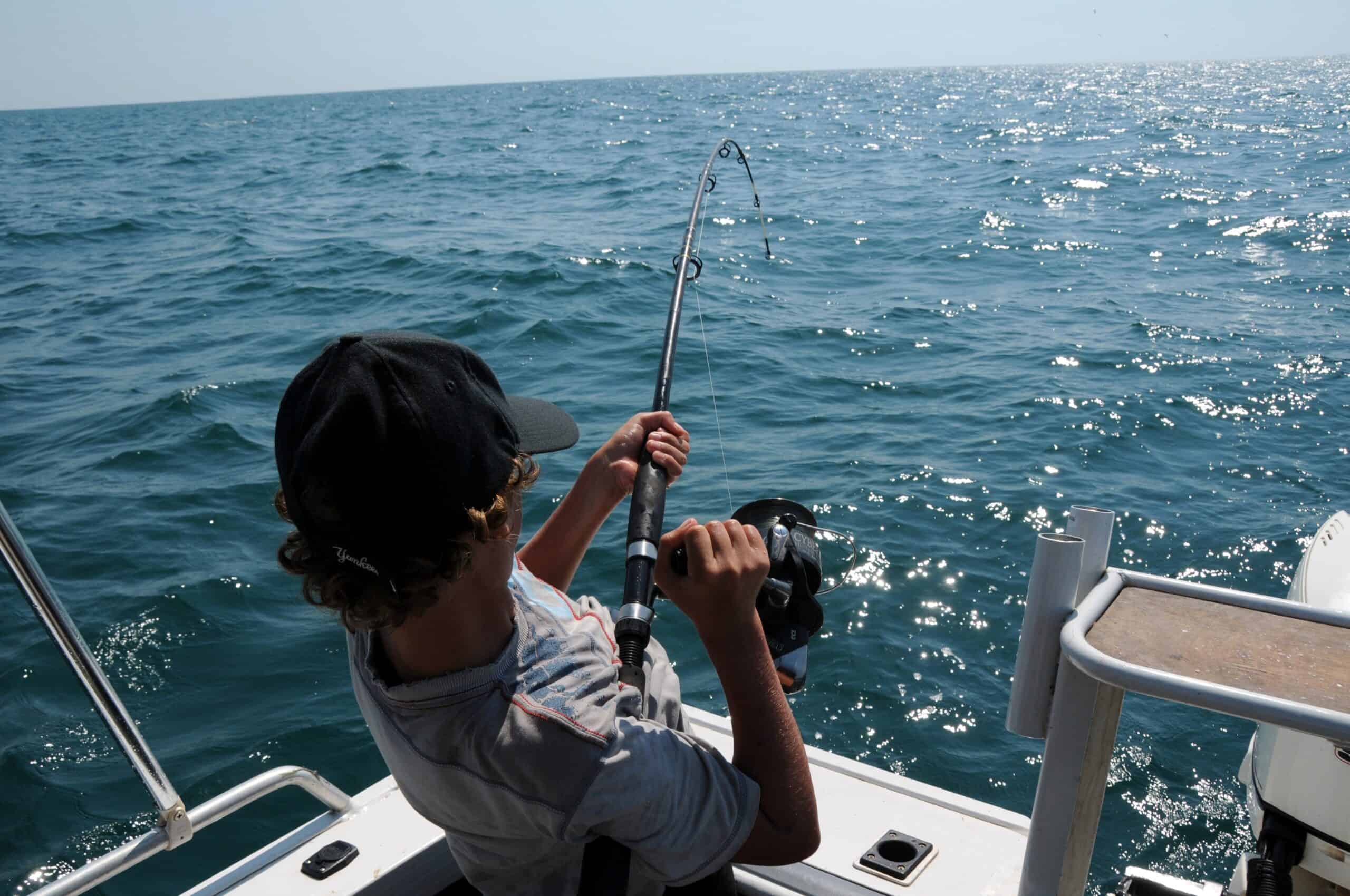 Man reeling in a fish (photo: Pexels)