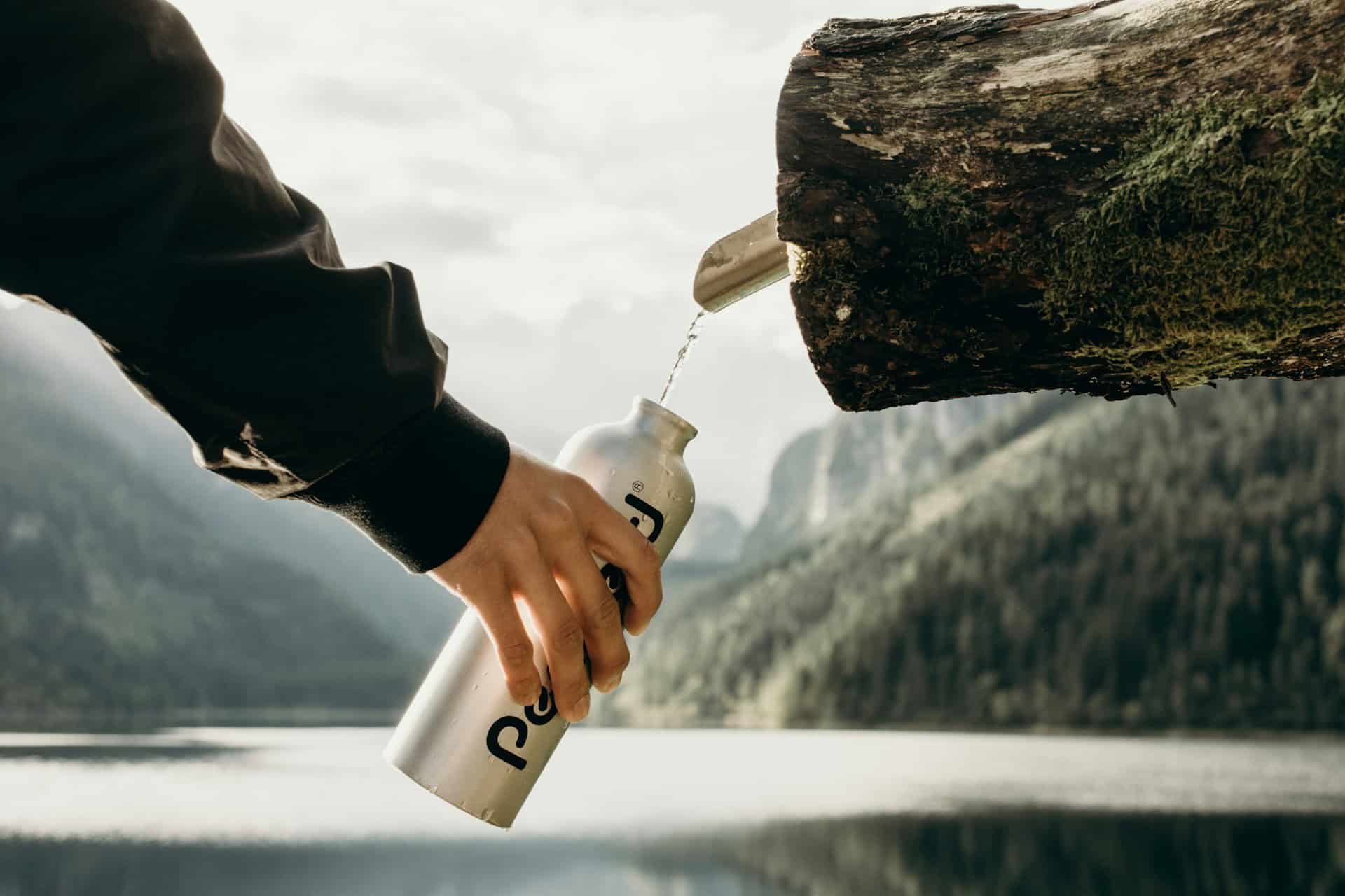 Filling a water bottle in the mountains (photo: Kate Joie)
