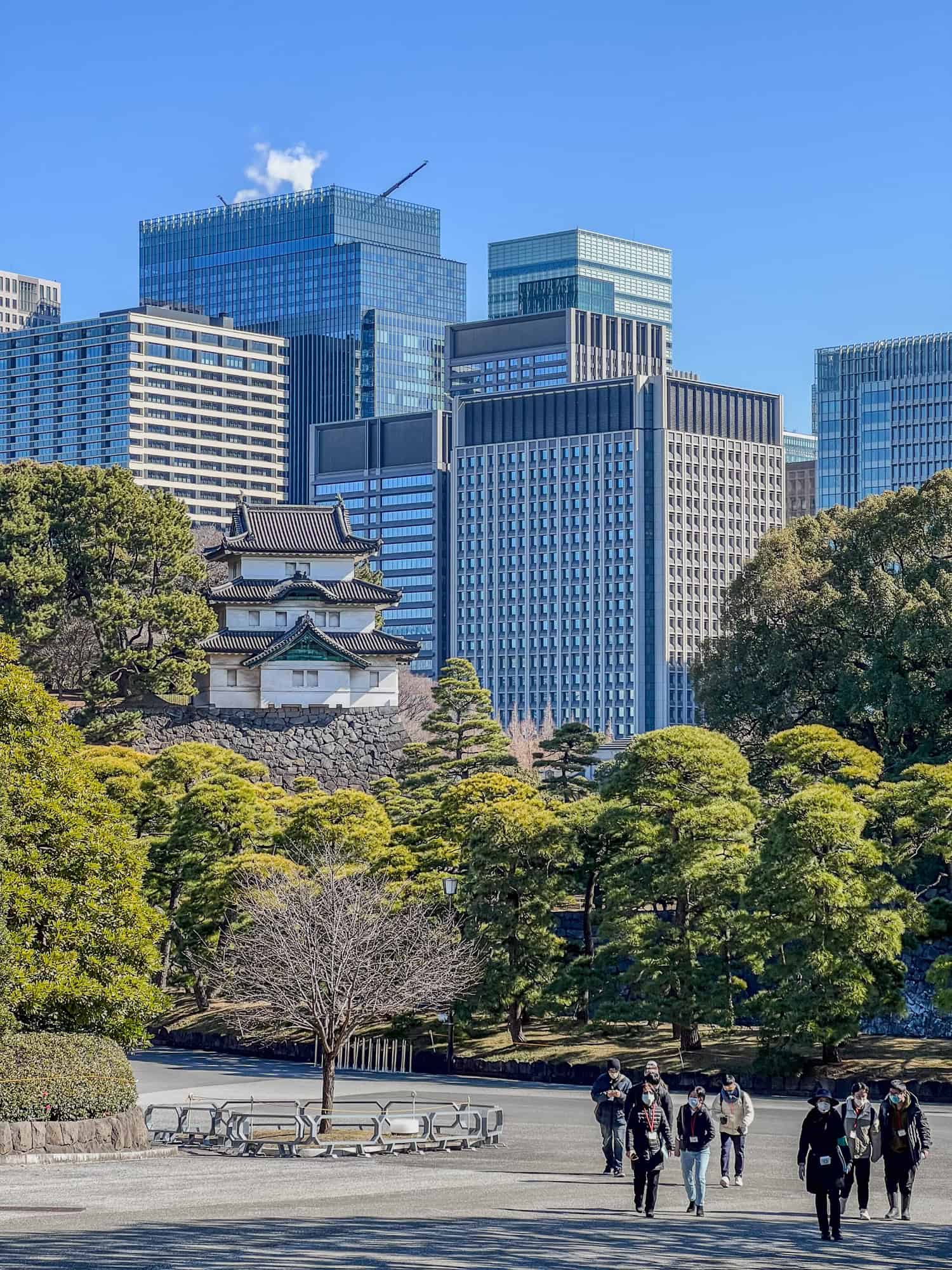 The Fujimi-yagura castle is overshadowed by the modern Marunouchi business district buildings in central Tokyo.