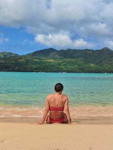 Woman sitting on the beach in Las Galeras, Dominican Republic (photo: Michael Baron)