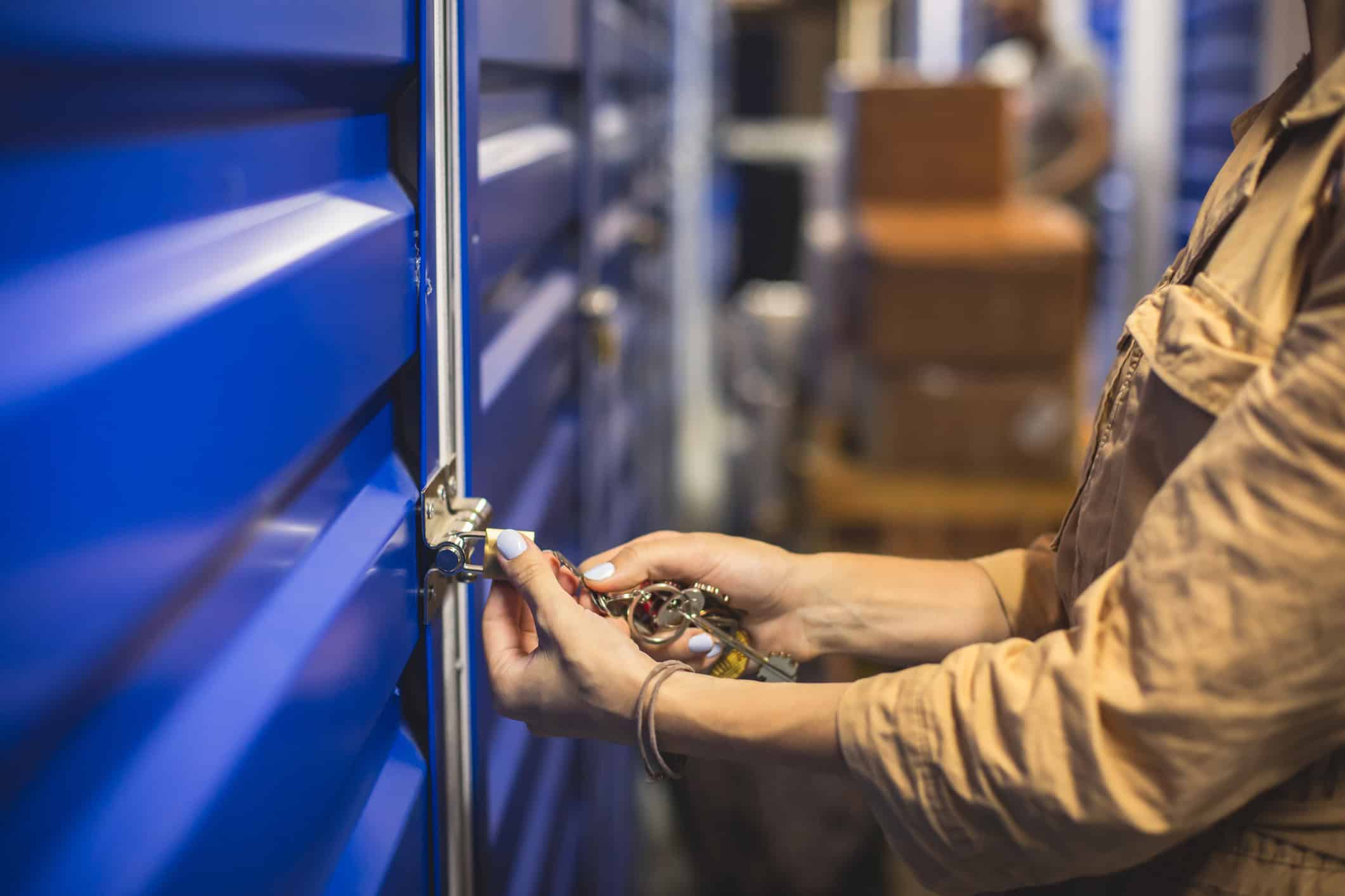 Woman unlocking storage unit (photo: Nikolay Tsuguliev, iStock license)