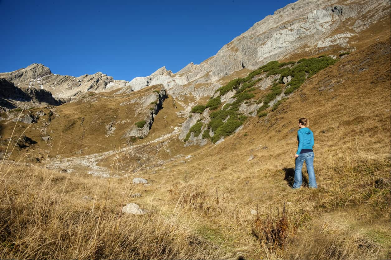 Woman walking in the Alps (photo: bbtomas, iStock)