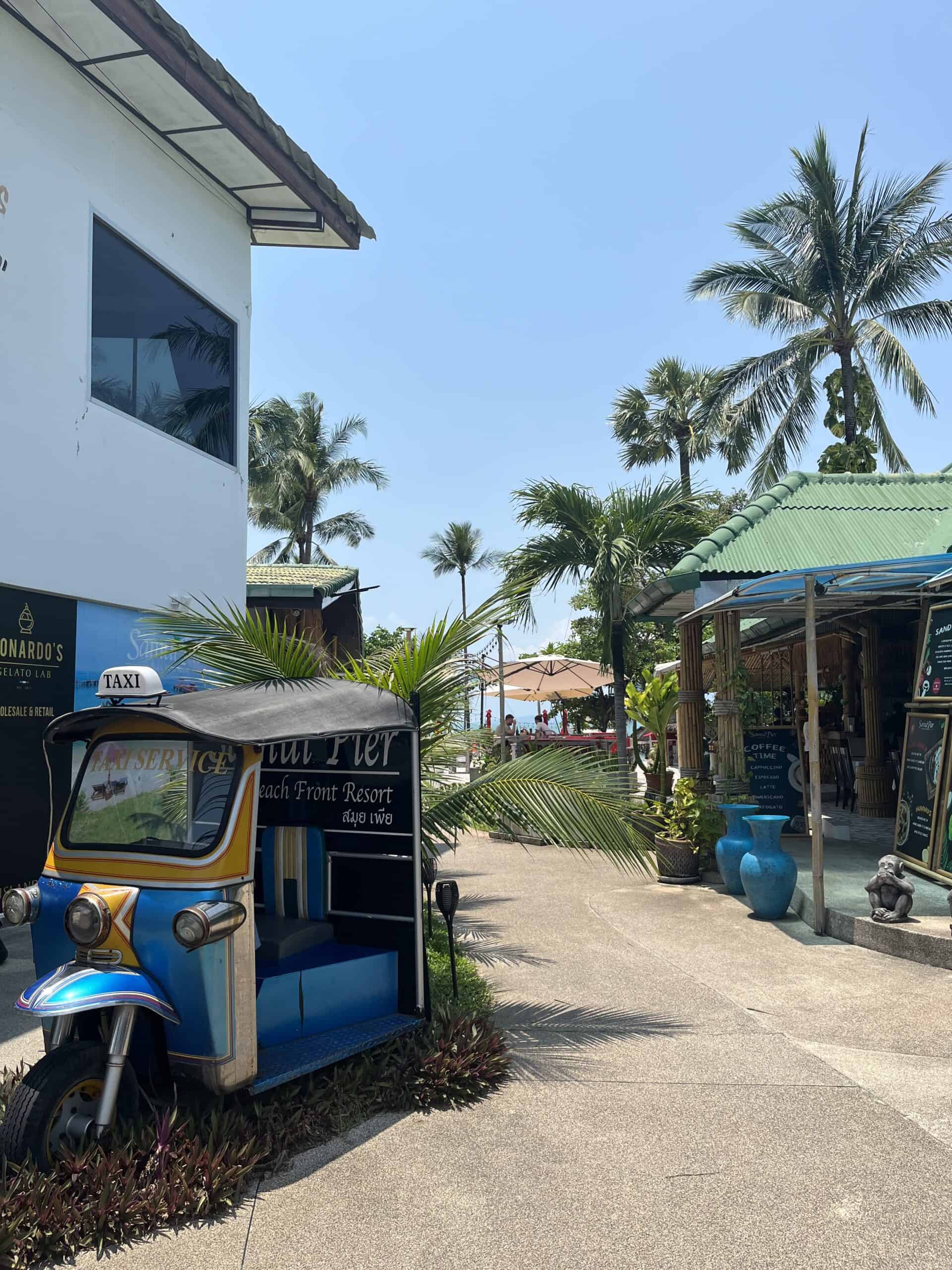 A tuk-tuk taxi on a path to the beach.
