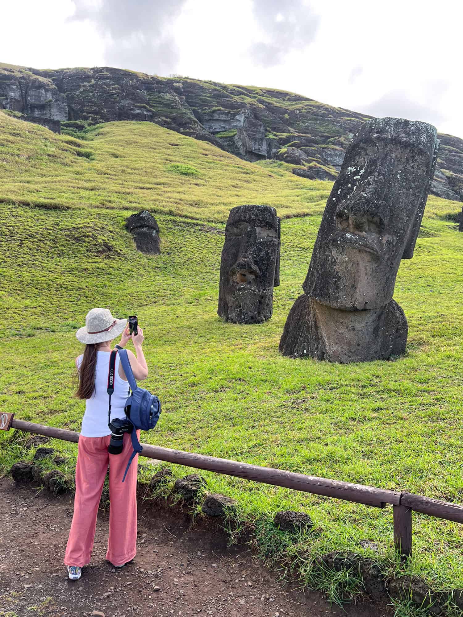 Kel photographing a moai statue.