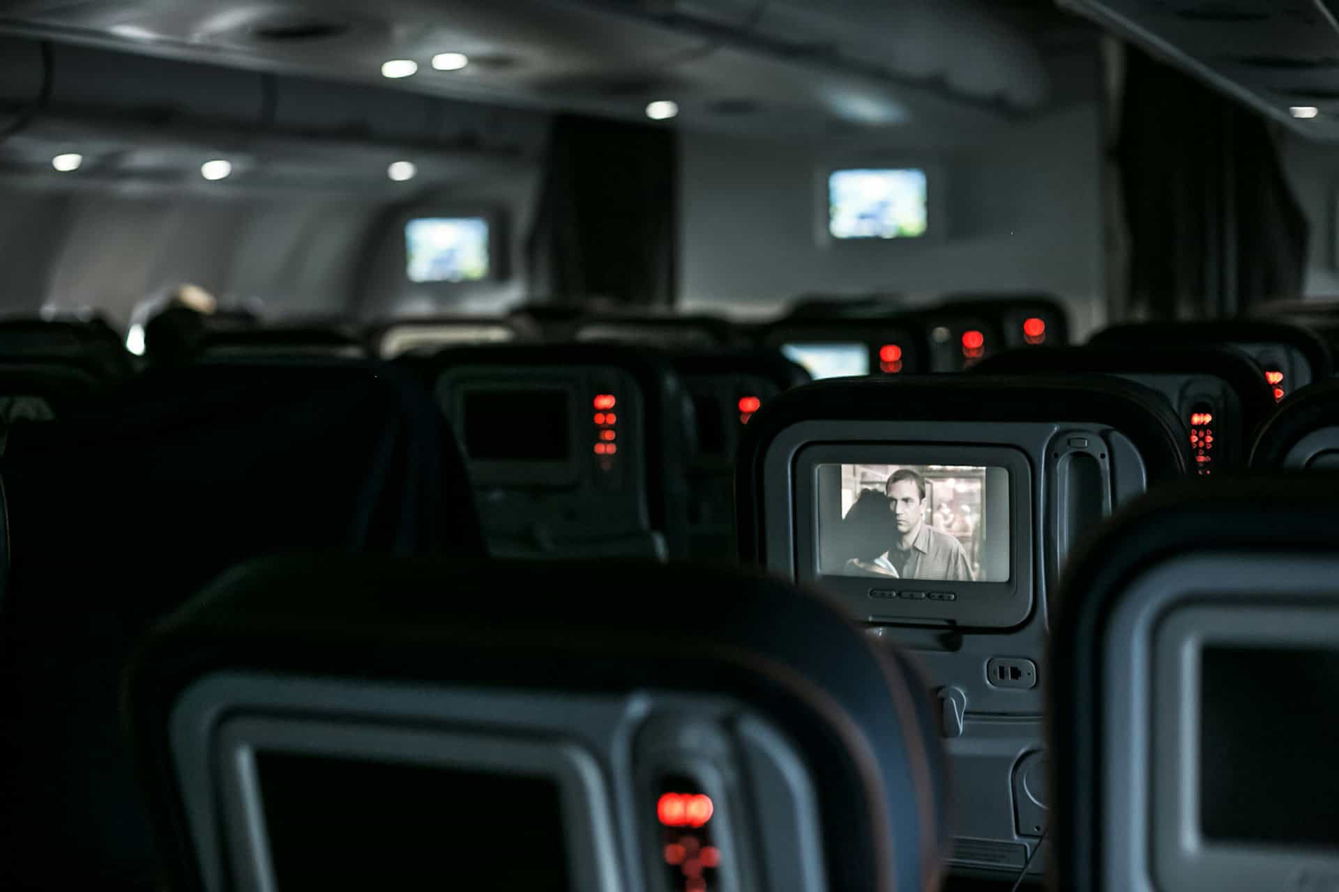 A movie plays on a seatback display on a plane (photo: Alev Takil).