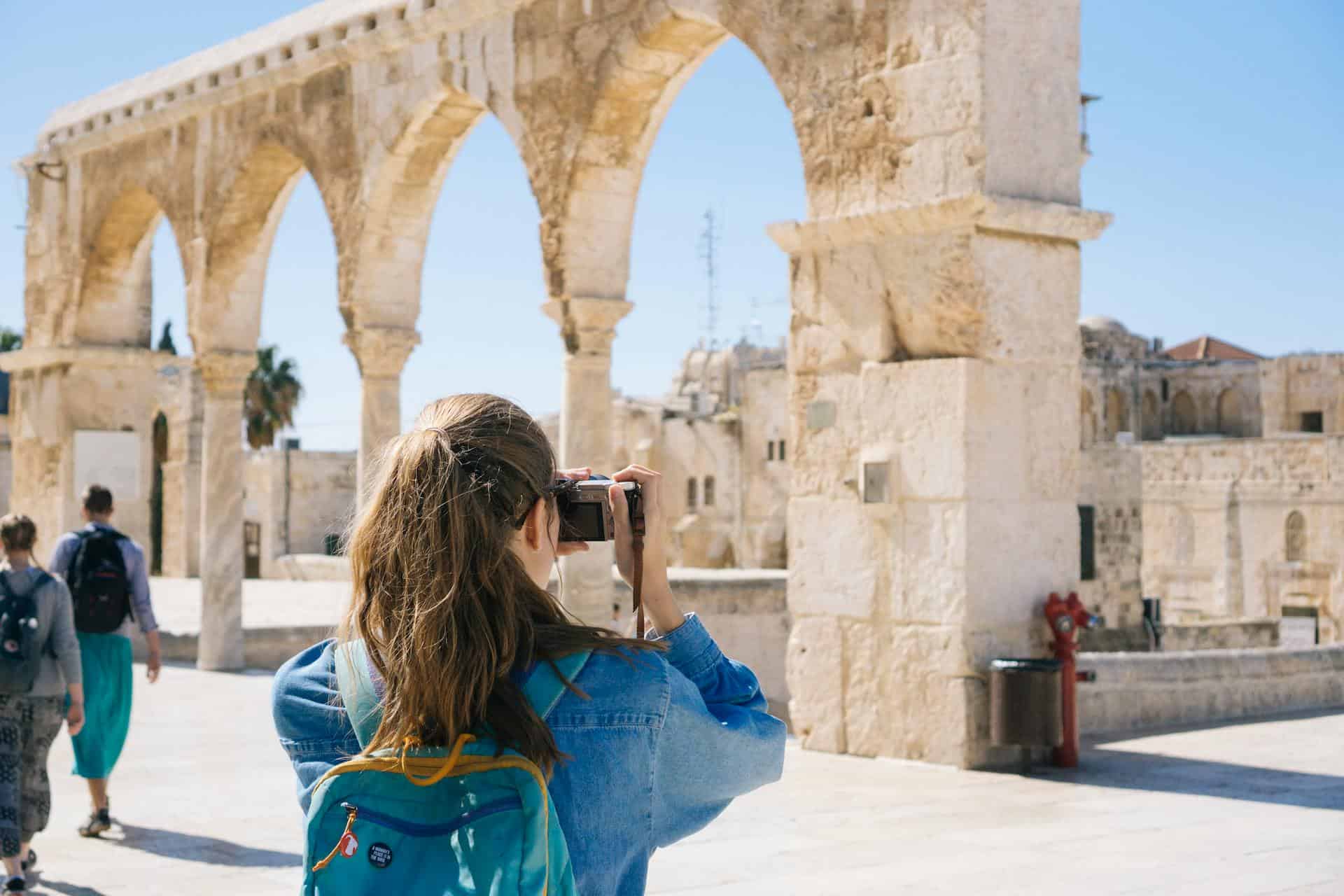 A tourist photographing ruins in Israel (photo: Haley Black).