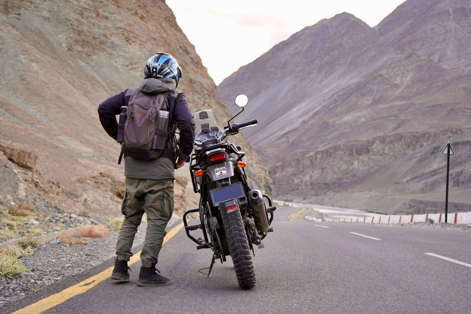 Driving through the Himalayas on a motorcycle (photo by Anand Yadav, Unsplash).