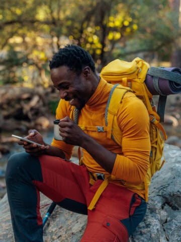 A hiker in Spain checks his smartphone (photo: Bernardbodo, iStock license).