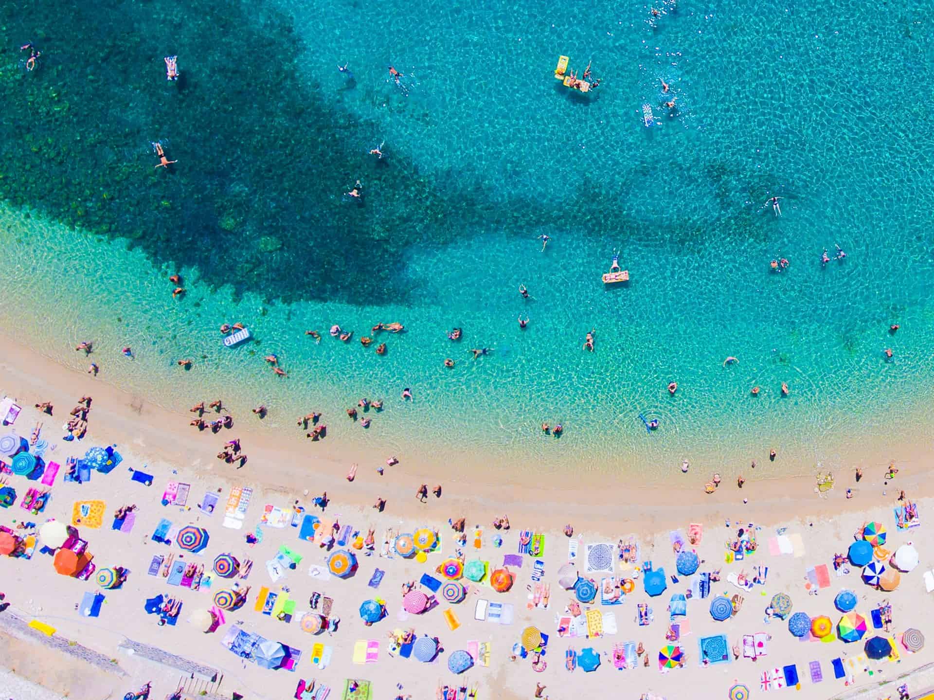 Aerial view of a beach and turquoise waters on Corfu (photo: Calin Stan, Unsplash).