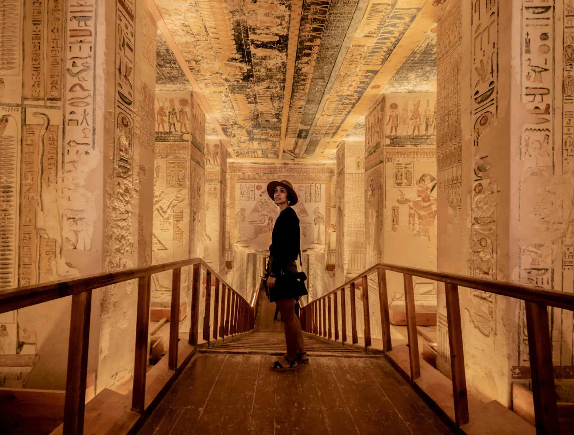 A traveler looks around inside a pharaoh's tomb in the Valley of the Kings, Egypt (photo: Michael Starkie, Unsplash).