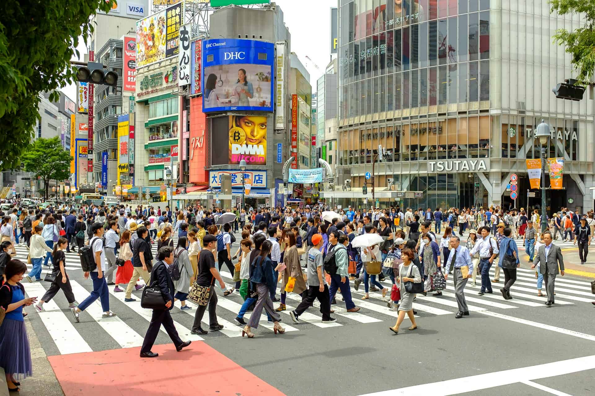 Crowds crossing Shibuya Crossing in Tokyo, Japan during the day