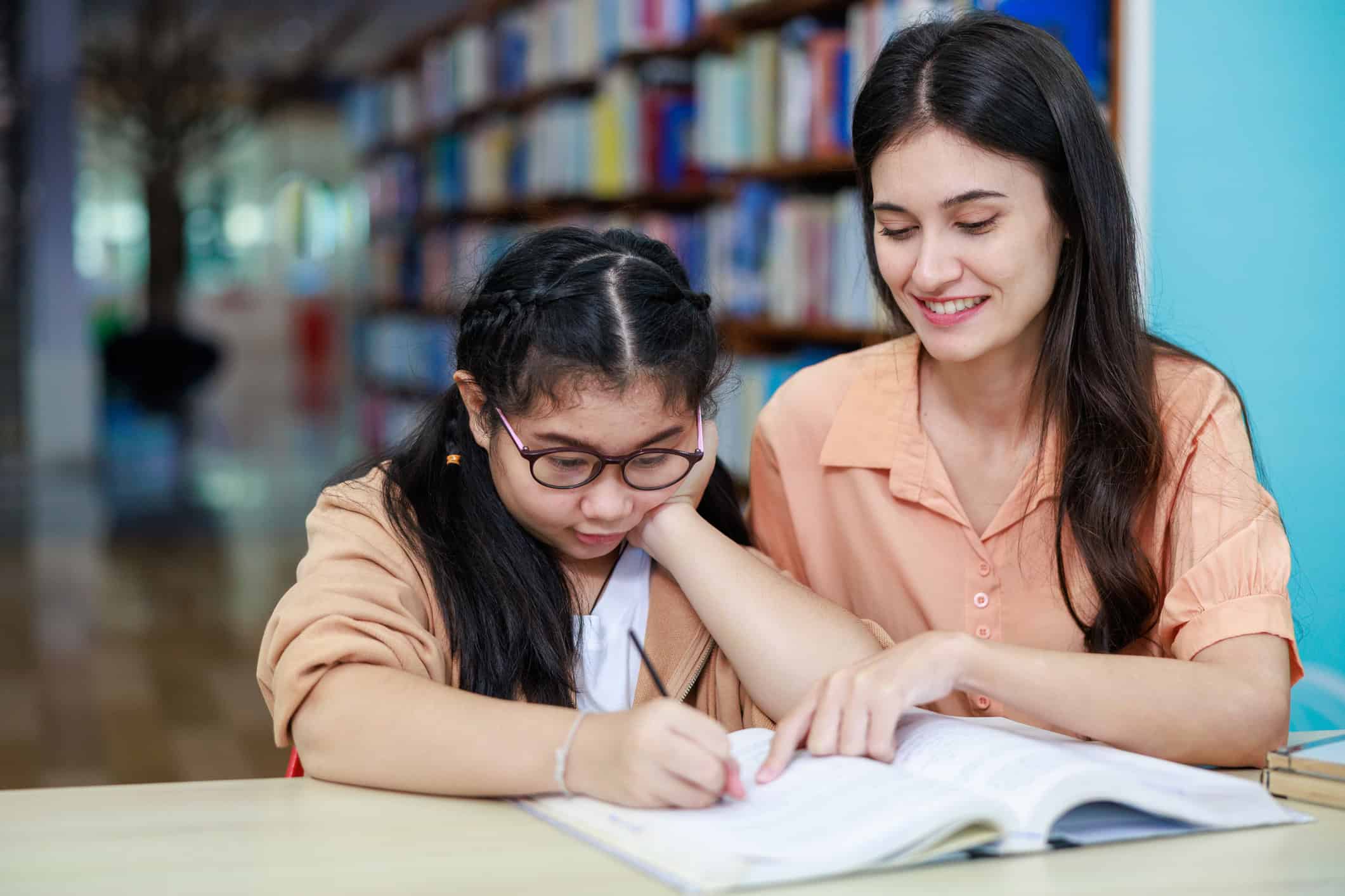 TEFL teacher helping a student with an English lesson in Thailand