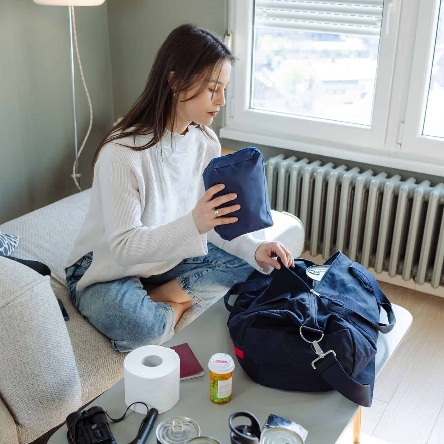 Packing a minimalist travel skincare kit into a small toiletry bag