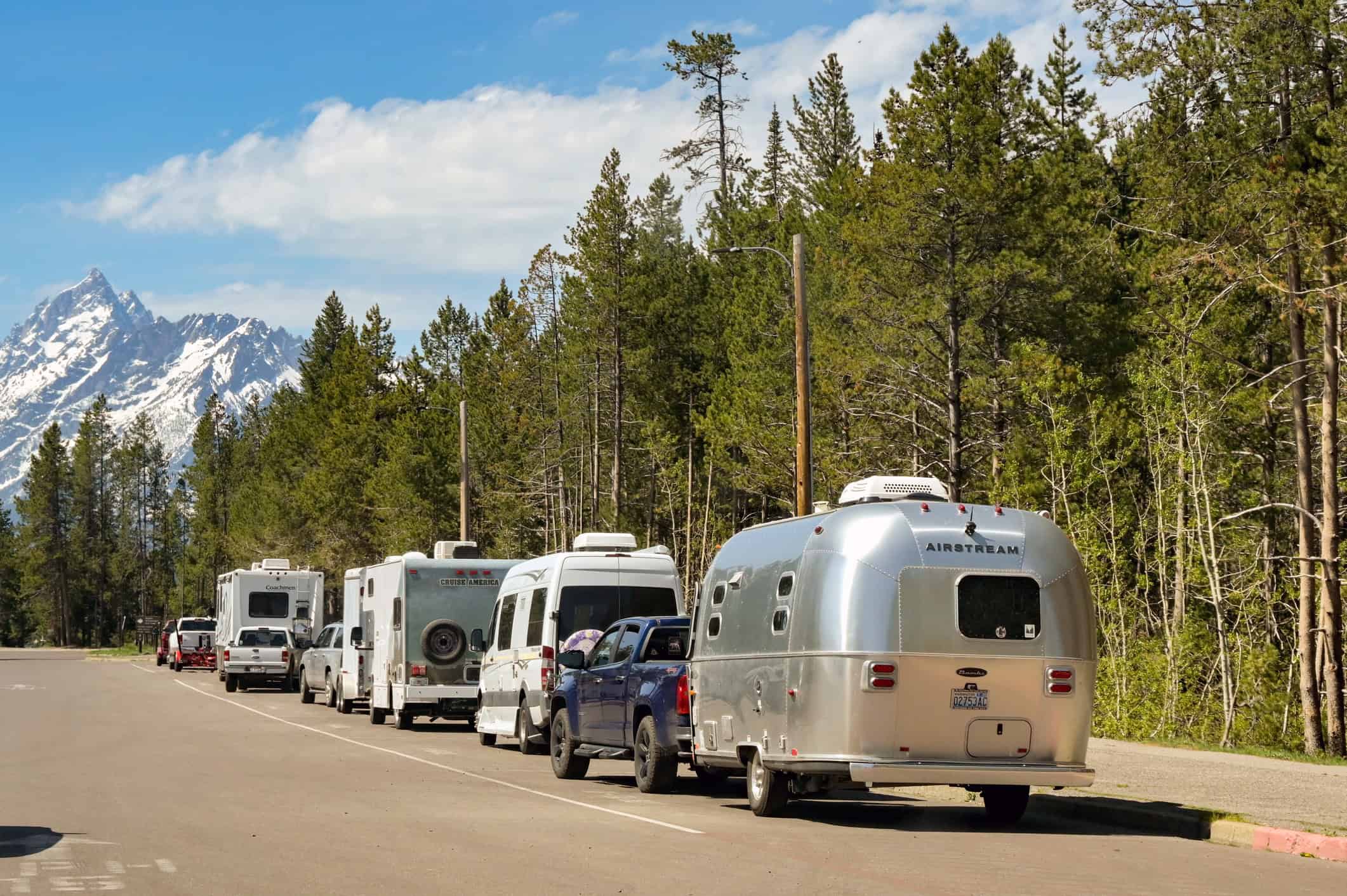 RVs and camper trailers parked near a campground during a road trip in Grand Teton National Park, Wyoming