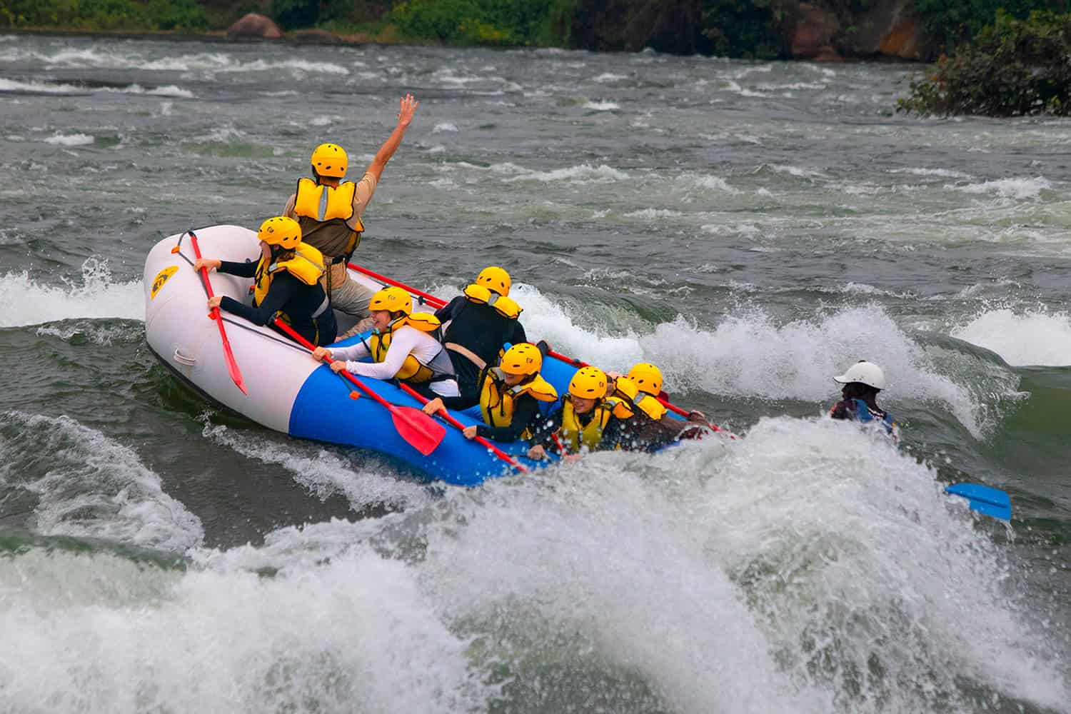 Raft crashing through Grade 5 rapids on the Nile River near Jinja, Uganda