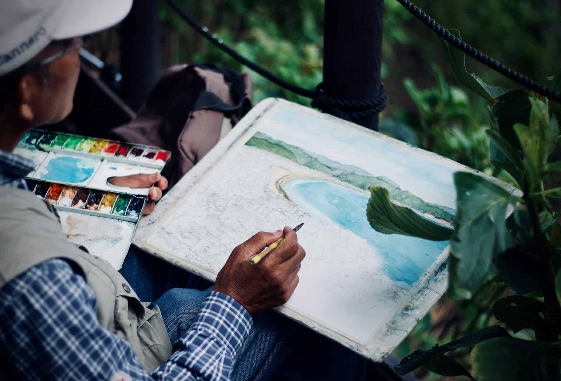 Traveler painting a watercolor landscape outdoors during a trip to Japan