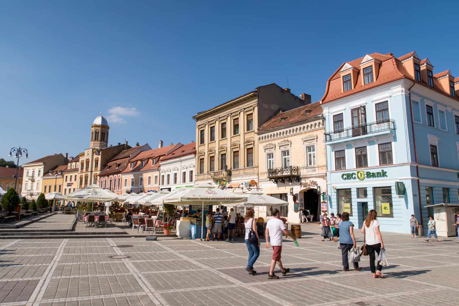 Council Square in Brasov, Romania with outdoor cafes and historic buildings