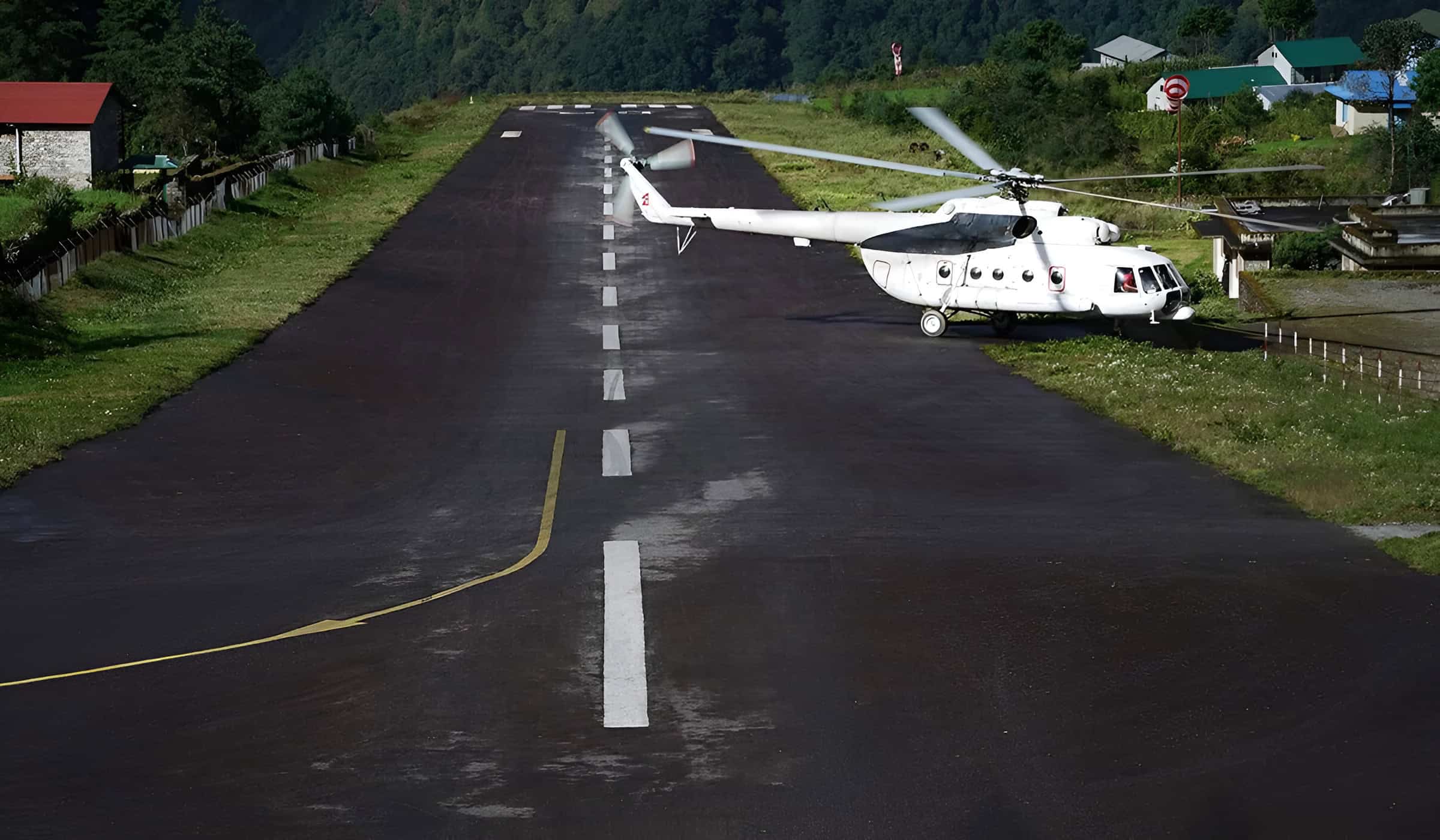 Helicopter on the runway at Lukla Airport in Nepal's Everest region.
