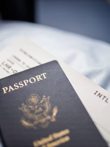 U.S. passport resting on top of an airline boarding pass before an international trip.