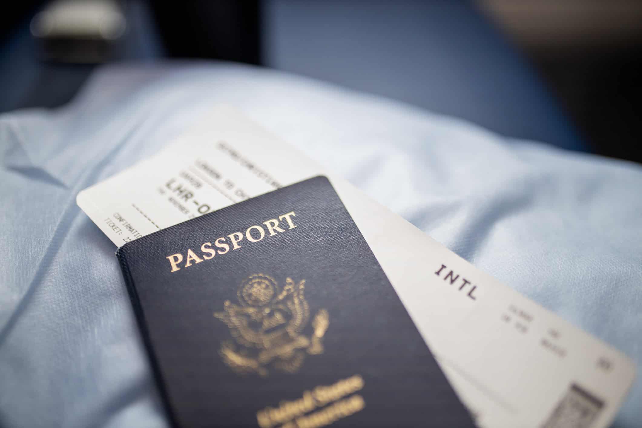 U.S. passport resting on top of an airline boarding pass before an international trip.