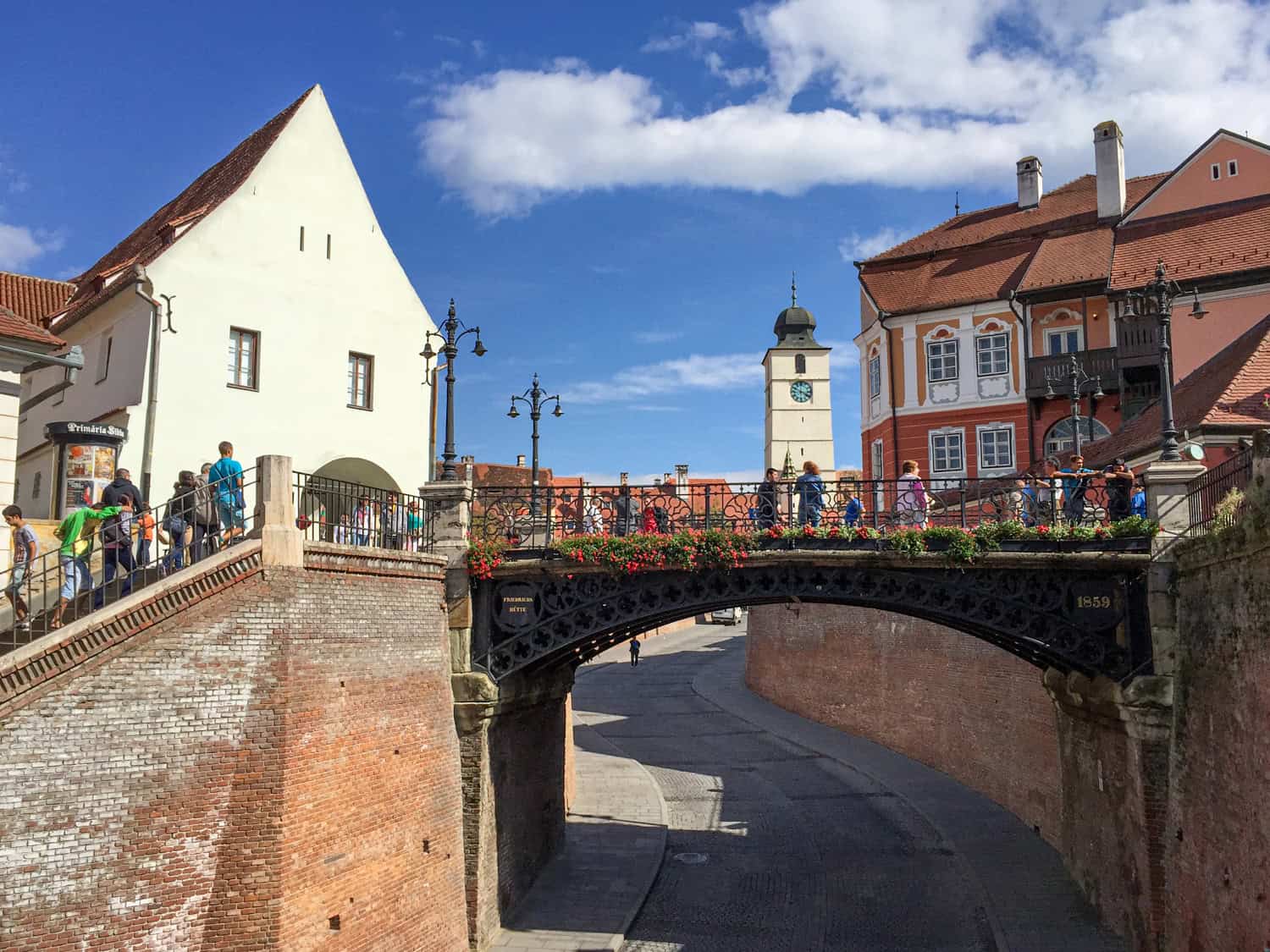Bridge of Lies in Sibiu, with historic buildings and pedestrians crossing the bridge