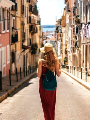 Traveler walking through a residential neighborhood in Lisbon, Portugal