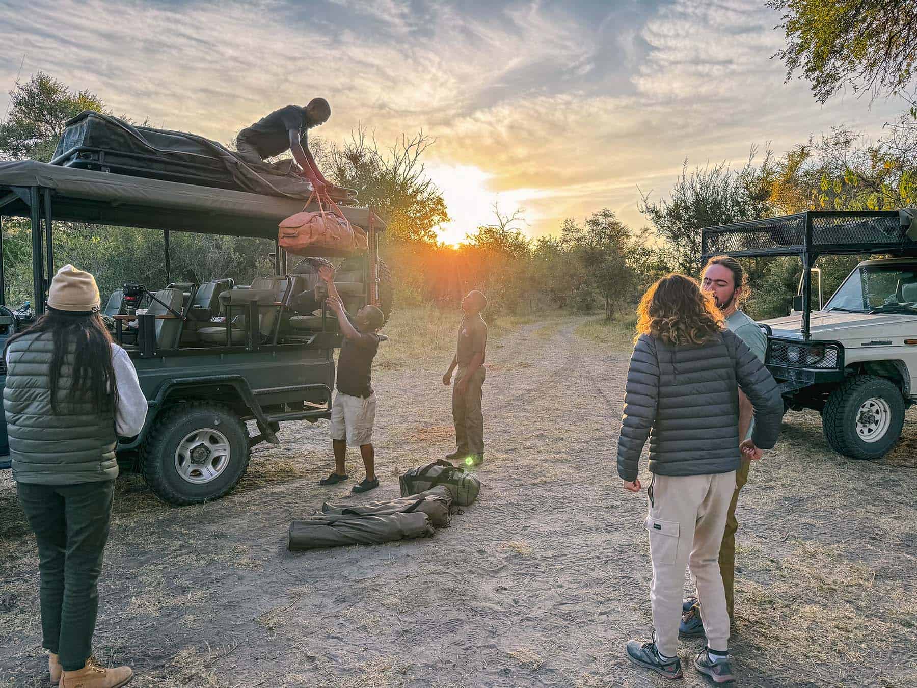 Soft-sided luggage being unloaded from the safari vehicle on safari in Botswana