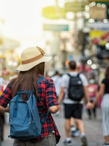 Backpacker walking through Khaosan Road in Bangkok during an international trip.