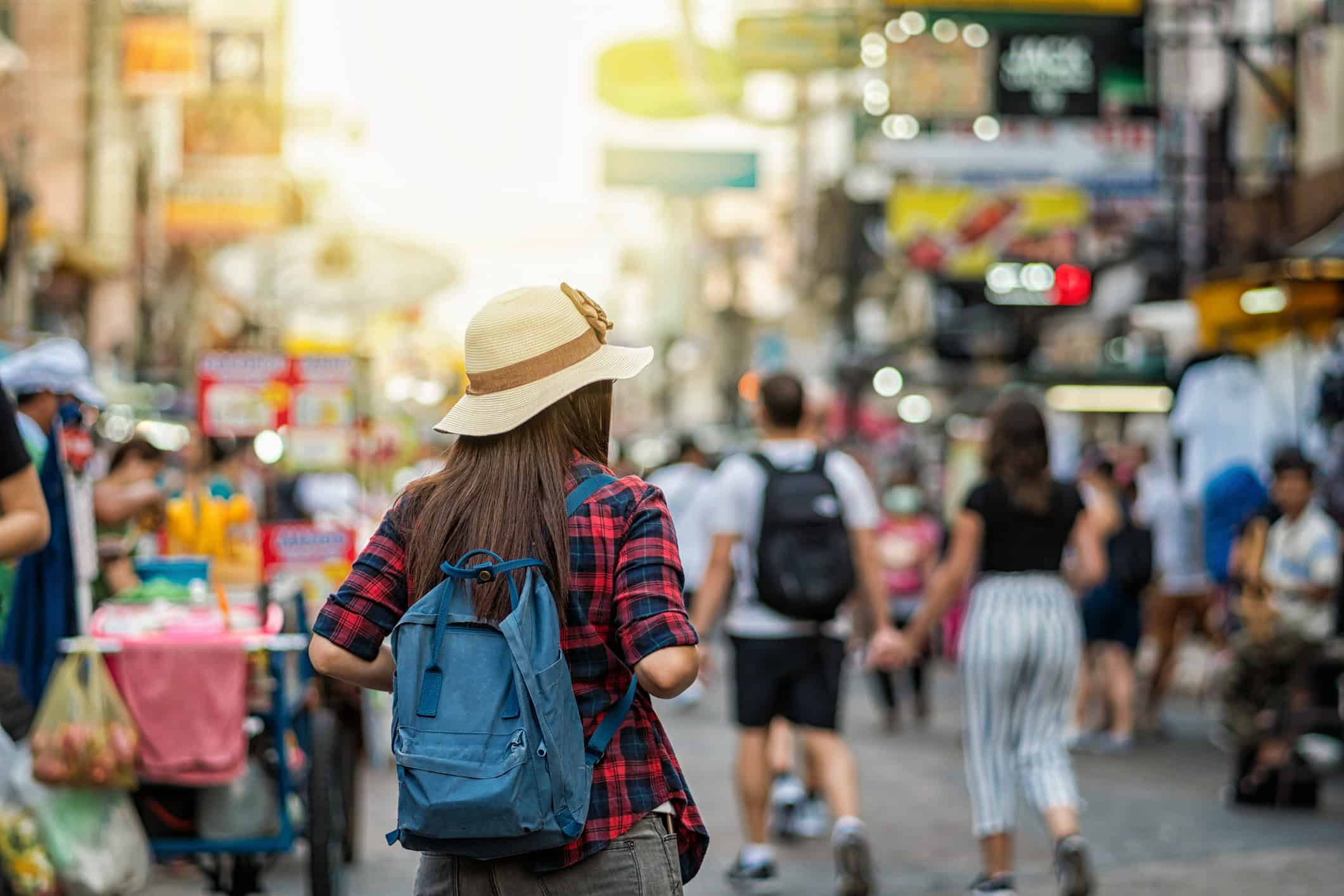 Backpacker walking through Khaosan Road in Bangkok during an international trip.